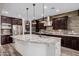 Modern kitchen featuring granite countertops, stainless steel appliances, and dark wood cabinetry at 4813 S Quantum Way, Mesa, AZ 85212