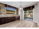 Butler's pantry featuring granite countertop, dark cabinets, and tiled backsplash and exterior view at 4813 S Quantum Way, Mesa, AZ 85212