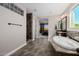 Main bathroom featuring an elegant tub, mosaic tile accents, and a walk-in shower at 4813 S Quantum Way, Mesa, AZ 85212