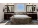 Beautiful main bathroom showcasing a central tub, dual vanities, and a tiled backsplash at 4813 S Quantum Way, Mesa, AZ 85212