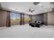 Large main bedroom with tray ceiling, ceiling fan, and an abundance of natural light at 4813 S Quantum Way, Mesa, AZ 85212