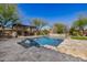 Backyard features a gorgeous pool, built-in grill, lounge chairs, and mature landscaping at 4813 S Quantum Way, Mesa, AZ 85212