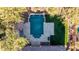 Aerial view of a private pool with a pergola, travertine deck, and lush green grass and shrubbery at 4813 S Quantum Way, Mesa, AZ 85212