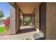 A covered porch with a table and chairs with a view of landscaping and a well kept neighborhood at 4813 S Quantum Way, Mesa, AZ 85212