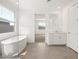 Bright bathroom featuring a soaking tub, shower, vanity, and light tile flooring at 4847 W Hunter Trl, San Tan Valley, AZ 85144