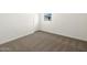 An empty carpeted bedroom with white walls and a window providing natural light at 4847 W Hunter Trl, San Tan Valley, AZ 85144