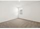 An empty carpeted bedroom with white walls and a window providing natural light at 4847 W Hunter Trl, San Tan Valley, AZ 85144