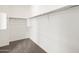 An empty closet with carpeted floors, white walls, and bars for hanging items at 4847 W Hunter Trl, San Tan Valley, AZ 85144