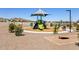 Community playground with slides and benches under a blue sky on manicured grounds at 4847 W Hunter Trl, San Tan Valley, AZ 85144