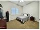 Spacious bedroom with carpeted floor, window blinds, and ceiling fan at 4905 W Magellan Dr, New River, AZ 85087