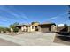 Tan colored house with a three-car garage and RV gate at 4905 W Magellan Dr, New River, AZ 85087