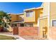 Front view of a yellow two-story townhome with a gated entrance at 510 N Alma School Rd # 158, Mesa, AZ 85201