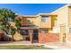 Front view of a yellow two-story townhome with a gated entrance at 510 N Alma School Rd # 158, Mesa, AZ 85201