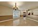 Bright dining room featuring a chandelier and tile flooring at 537 W El Caminito Dr, Phoenix, AZ 85021