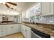 Modern kitchen with granite counters, white cabinets, and stainless steel appliances at 537 W El Caminito Dr, Phoenix, AZ 85021