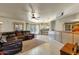 Open living room with leather sectional and view into kitchen at 537 W El Caminito Dr, Phoenix, AZ 85021