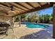 Relaxing kidney shaped pool with covered patio and outdoor dining at 537 W El Caminito Dr, Phoenix, AZ 85021