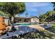 Kidney-shaped pool with surrounding patio at 537 W El Caminito Dr, Phoenix, AZ 85021