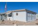 Side view of a white manufactured home with American flag at 5646 E Player Pl, Mesa, AZ 85215