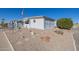 Side view of a white manufactured home with gravel landscaping at 5646 E Player Pl, Mesa, AZ 85215