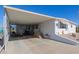 Covered patio and parking area of a white manufactured home at 5646 E Player Pl, Mesa, AZ 85215