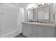 Bathroom with double vanity, white subway tile and bathtub at 5714 E Paradise Ln, Scottsdale, AZ 85254