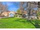 Landscaped lawn with mature trees and a single-story home at 5714 E Paradise Ln, Scottsdale, AZ 85254