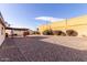 Gravel backyard with a covered patio and shed at 6026 W Juniper Ave, Glendale, AZ 85306