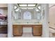 Bathroom features a double vanity with wood cabinets and a large mirror at 6026 W Juniper Ave, Glendale, AZ 85306