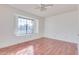 Bedroom with wood flooring and large window at 6026 W Juniper Ave, Glendale, AZ 85306