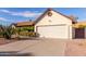 House exterior featuring a large garage and desert landscaping at 6026 W Juniper Ave, Glendale, AZ 85306