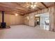 Gathering room with wood paneling, wood-burning stove, and carpet at 6026 W Juniper Ave, Glendale, AZ 85306