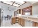 Open kitchen with stainless steel appliances and a view into the dining area at 6026 W Juniper Ave, Glendale, AZ 85306