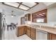 Kitchen features wood cabinets, stainless steel dishwasher, and adjacent dining area at 6026 W Juniper Ave, Glendale, AZ 85306