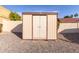 Tan colored storage shed in the backyard at 6026 W Juniper Ave, Glendale, AZ 85306