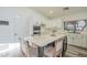 Kitchen with white cabinets, a large island, and a view of the backyard at 605 S 30Th Cir, Mesa, AZ 85204