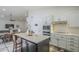 Modern kitchen with white cabinets, quartz countertops, and a large island at 605 S 30Th Cir, Mesa, AZ 85204