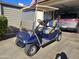 Blue golf cart parked in driveway, great for community use at 650 N Hawes Rd # 4430, Mesa, AZ 85207