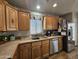 Kitchen boasts ample counter space, wood cabinets, and a stainless steel dishwasher at 650 N Hawes Rd # 4430, Mesa, AZ 85207