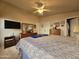 Main bedroom with a large bed, dresser and TV at 650 N Hawes Rd # 4430, Mesa, AZ 85207