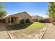 Landscaped backyard with grassy area and patio at 6602 W Prickly Pear Trl, Phoenix, AZ 85083