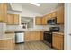 Kitchen with wood cabinets, stainless steel appliances, and tile flooring at 6602 W Prickly Pear Trl, Phoenix, AZ 85083