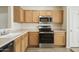 Kitchen with wood cabinets, stainless steel appliances, and tile flooring at 6602 W Prickly Pear Trl, Phoenix, AZ 85083