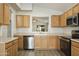 Kitchen with wood cabinets, stainless steel appliances, and tile flooring at 6602 W Prickly Pear Trl, Phoenix, AZ 85083