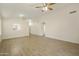 Spacious living room with tile floors and a view into the kitchen at 6602 W Prickly Pear Trl, Phoenix, AZ 85083