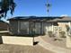 Tan single story home with walkway, small yard, and palm tree at 6711 W Osborn Rd # 96, Phoenix, AZ 85033