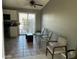 Combined kitchen and dining area with tile floors, white cabinets, and access to a patio at 6711 W Osborn Rd # 96, Phoenix, AZ 85033