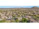 Aerial view of home in a residential neighborhood with mountain backdrop at 6857 W Juana Dr, Peoria, AZ 85383