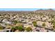 Aerial view of the home and surrounding community, mountains in the distance at 6857 W Juana Dr, Peoria, AZ 85383