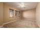 Bright bedroom with ceiling fan and neutral carpeting at 6857 W Juana Dr, Peoria, AZ 85383